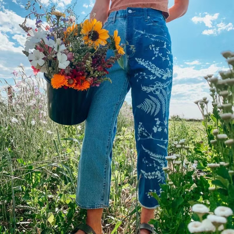 Konstnär och fotograf Kellieswanson skriver ut jackor, jeans och andra kläder med en mörkblå solbrunt tryck
